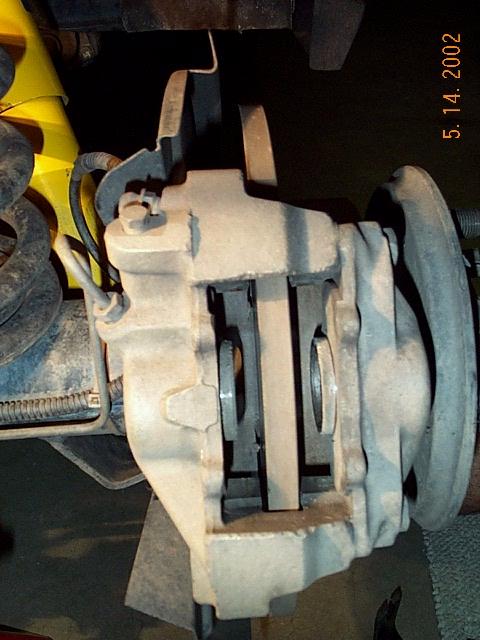 rear brakes no pads.JPG